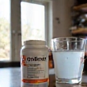 EnerCore Vitality Blend in use, next to a glass of water